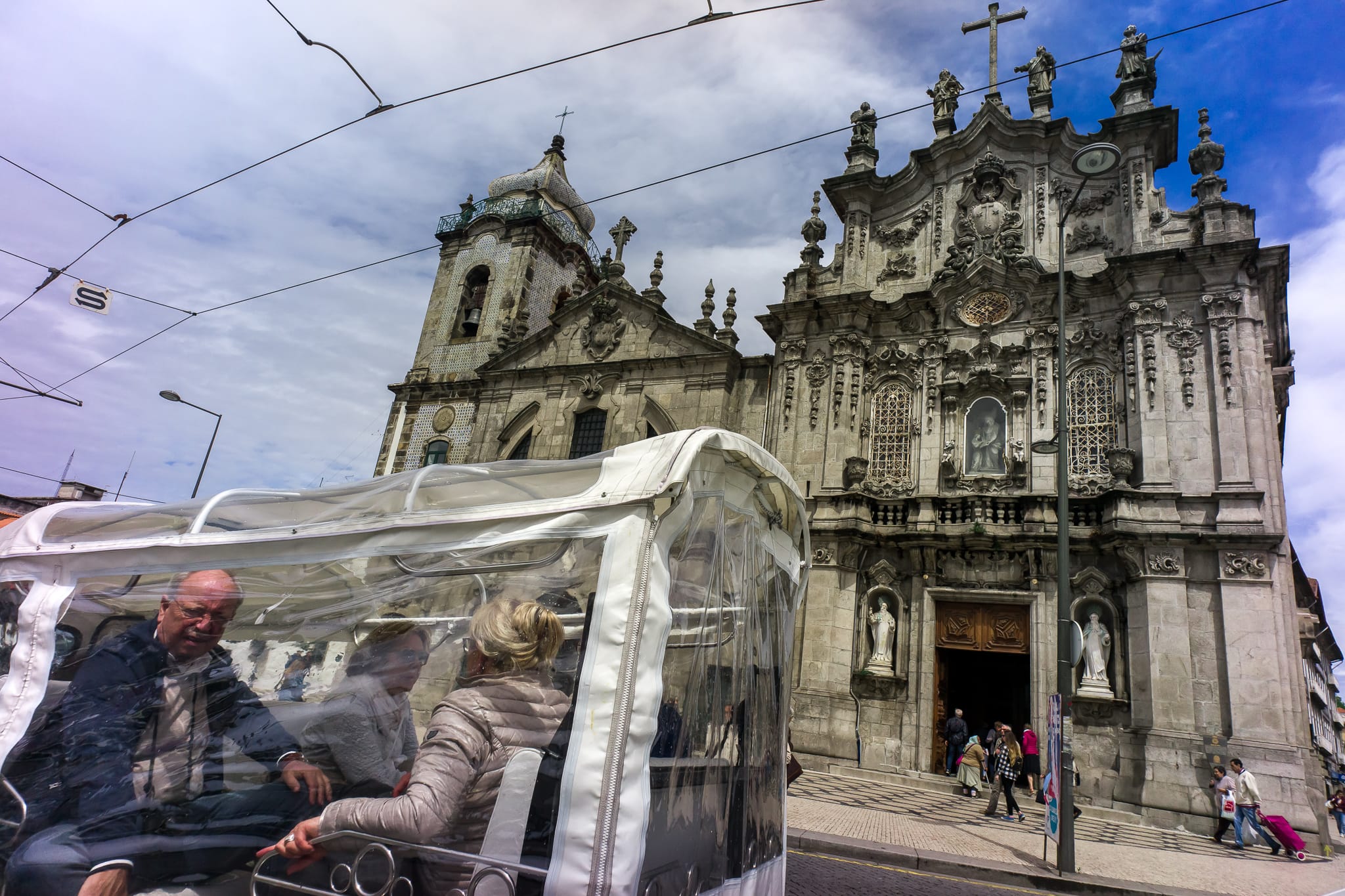 Tourists in tuk-tuk in front of Igreja do Carmo church Tourists in tuk-tuk in front of Igreja do Carmo church